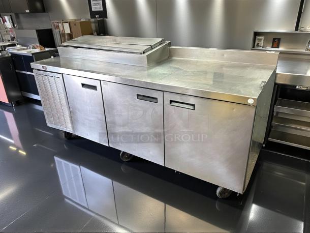 Delfield 91in 3-door refrigerated pizza prep in excellent condition, on casters, model 000-20191PTC, 115v.
