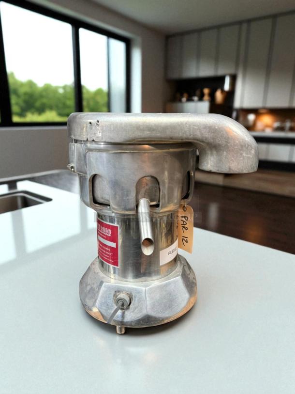 Ruby 2000 Commercial Juice Extractor, stainless steel, tested and working, 115v. Visible tag reads "PAR 12."