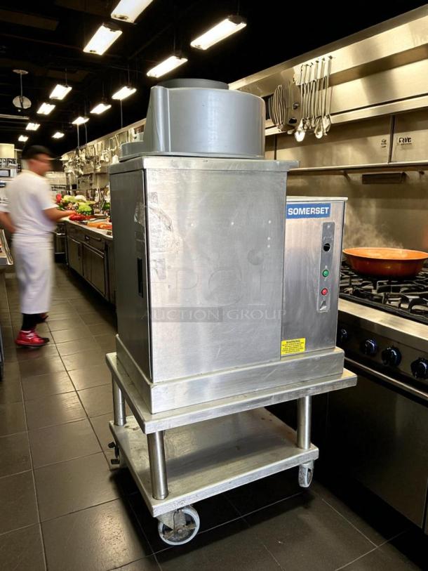Somerset SDR-400 dough rounder, excellent condition, stainless steel, 110V, tested, working, on wheeled stand in kitchen.