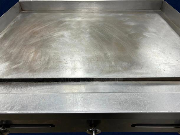 Stratus SMG36 griddle flat top grill, gas-powered, tested, working, great condition, metal surface, control knobs visible.