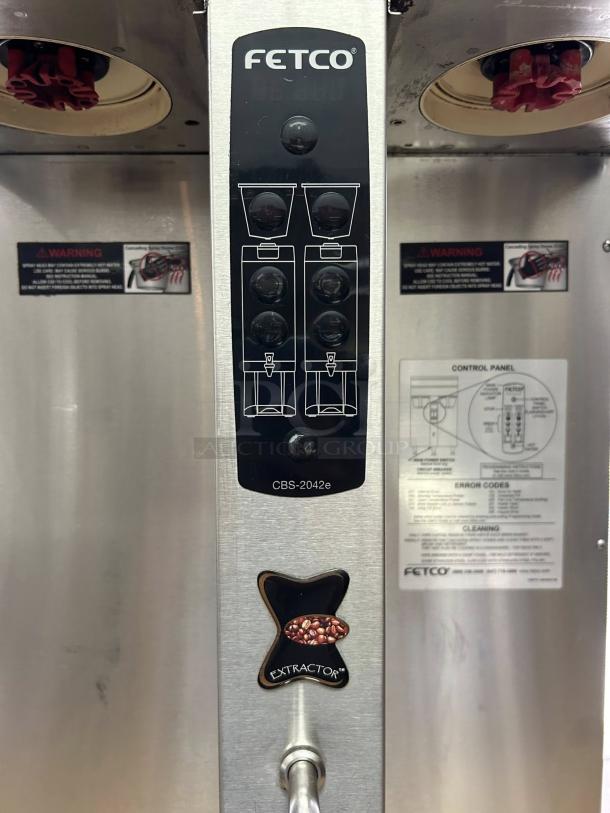 Fetco CBS-2042e Twin 1 Gallon Coffee Brewer in excellent condition. Features control panel, warning labels, fully tested.