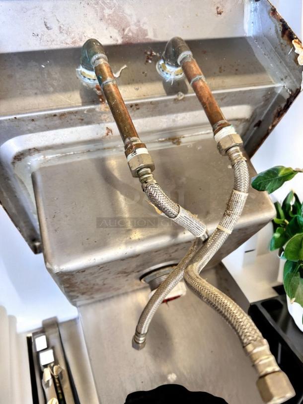 Stainless steel wall-mount hand sink with faucet, fully tested, excellent condition, visible plumbing, clean surface.