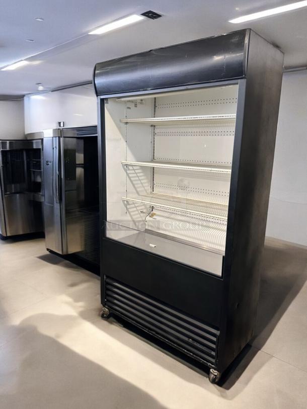 True TAC-48 air curtain merchandiser in excellent condition, 208/230V, fully tested and working, on castor wheels.
