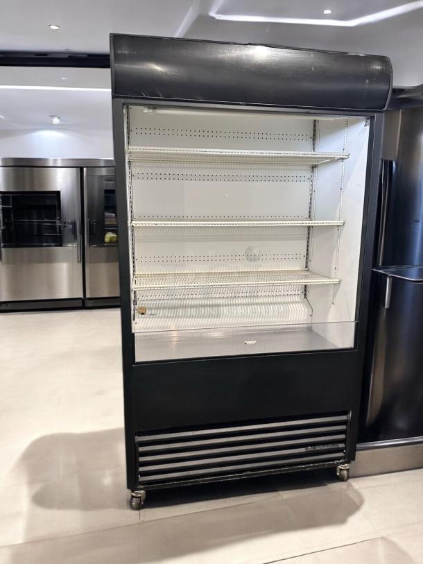 True TAC-48 air curtain merchandiser in excellent condition, 208/230V, fully tested. Features multiple shelves, sleek black exterior.