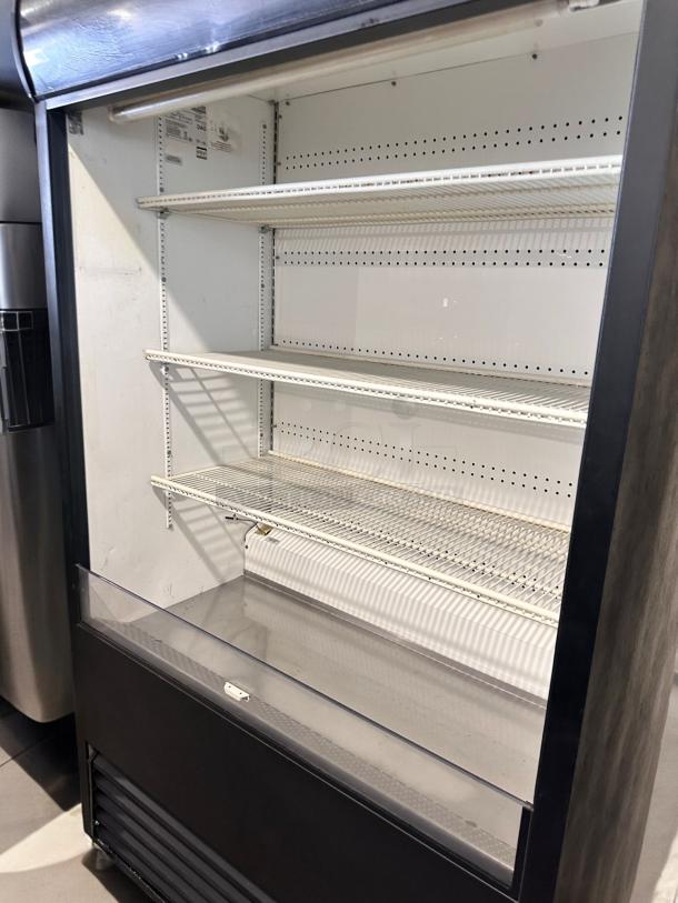 True TAC-48 air curtain merchandiser in excellent condition, 208/230V, fully tested and working, with multiple shelves and clear front.