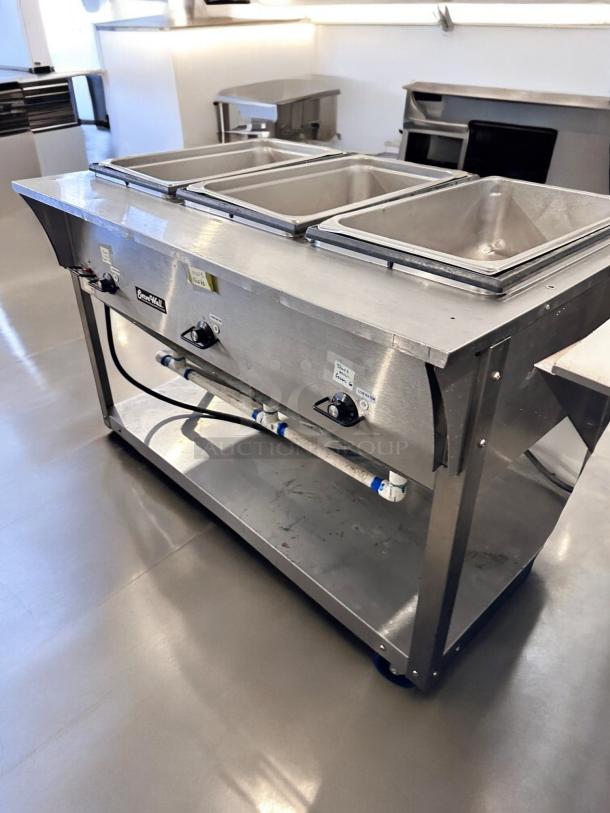 Vollrath ServeWell 387013 3-Well Steam Table in excellent condition, stainless steel, 120V, with visible control knobs and labels.