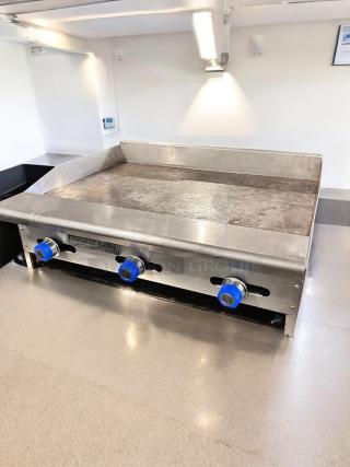 American Range 36" gas griddle, excellent condition, manual controls, tested and working. Features blue knob controls.