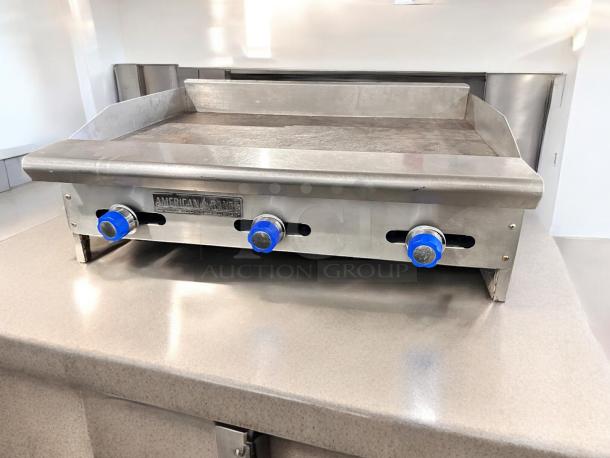 American Range 36" gas griddle in excellent condition, manual controls, fully tested, blue knobs, stainless steel finish.