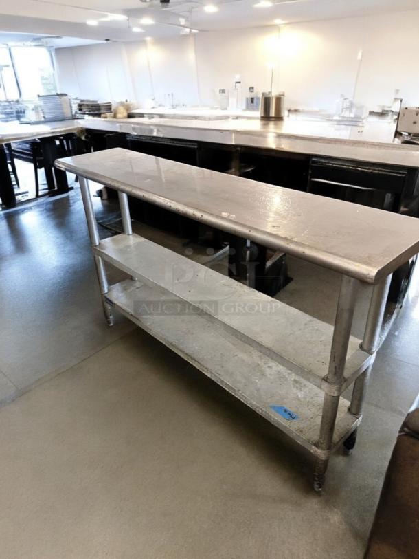 Stainless steel work table, 60" x 18", excellent condition, features two undershelves, fully tested and operational.