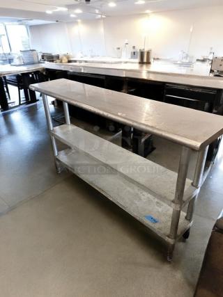 Stainless steel work table, 60" x 18", excellent condition, features two undershelves, fully tested and operational.
