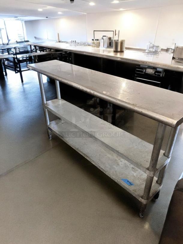 Stainless steel work table with two undershelves, 60" x 18", excellent condition, fully operational, visible blue label.