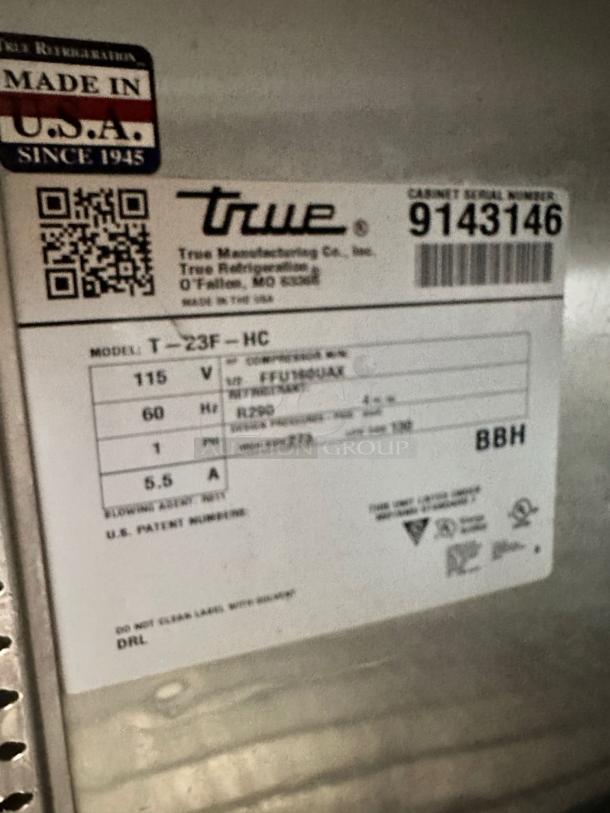 Label on True T-23F-HC commercial freezer showing model, voltage, and serial number, emphasizing "Made in USA" tag.