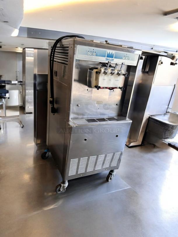 Taylor Y339-27 soft serve ice cream machine, excellent condition, 208/230V, fully tested, stainless steel finish, on wheels.