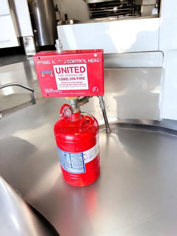 PyroChem PCL-160 Kitchen Knight II fire suppression system in excellent condition, fully tested, with operational labels visible.