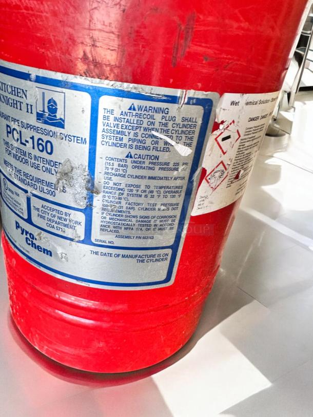 PyroChem PCL-160 Kitchen Knight II Fire Suppression System in excellent condition, fully tested, with clear label detailing usage warnings and specifications.