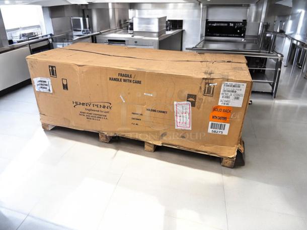 Henny Penny HHC900.24 Heated Holding Cabinet, new in factory-sealed box, solid back, with casters, 120V, labeled "Fragile".