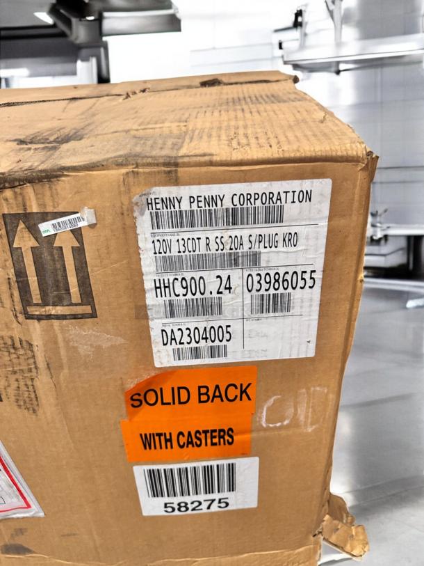 Brand new Henny Penny HHC900.24 heated holding cabinet, solid back, with casters, 120V, factory sealed, labeled.