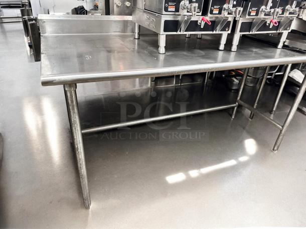 Commercial grade stainless steel work table in excellent condition, 36"W x 30"D x 36"H, fully tested and functional.
