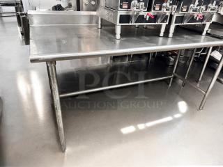 Commercial grade stainless steel work table in excellent condition, 36"W x 30"D x 36"H, fully tested and functional.