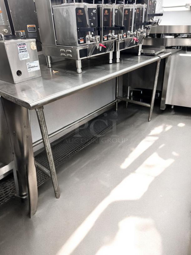 Stainless steel work table, 36"W x 30"D x 36"H in excellent condition, fully tested, commercial grade.