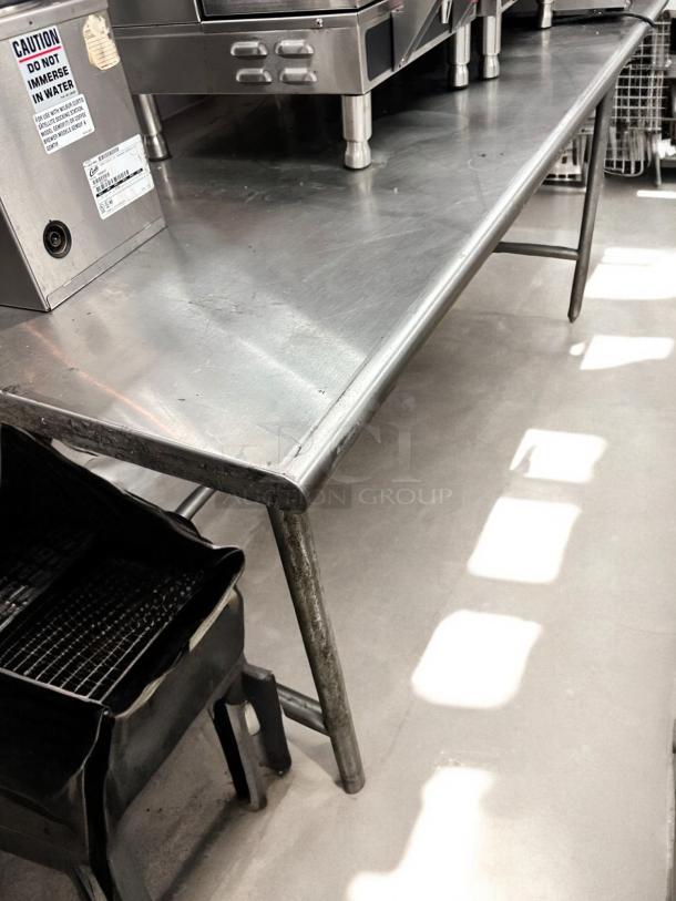 Commercial grade stainless steel work table, 36"W x 30"D x 36"H, excellent condition, visible caution label.