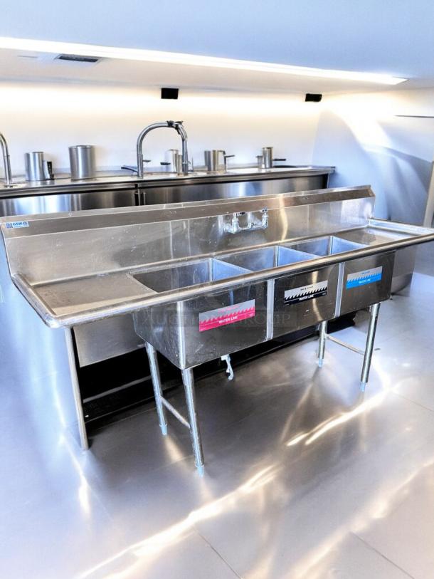 GSW 3-compartment stainless steel sink with dual drainboards, excellent condition, NSF certified, fully tested and working.