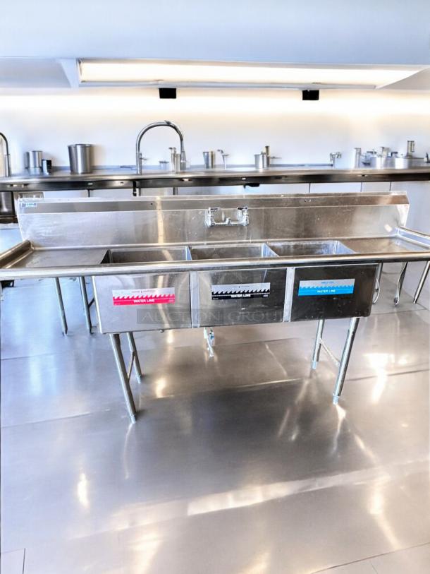 GSW 3-compartment stainless steel sink with dual drainboards, excellent condition, NSF certified, fully tested and working.