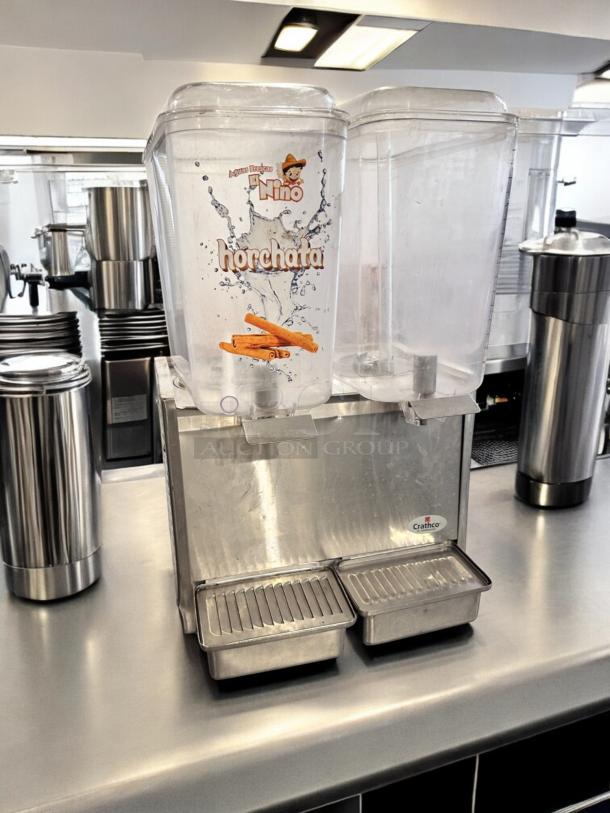 Crathco D25-3 dual bowl beverage dispenser, 115V, excellent condition, stainless steel base, fully tested, visible brand label.