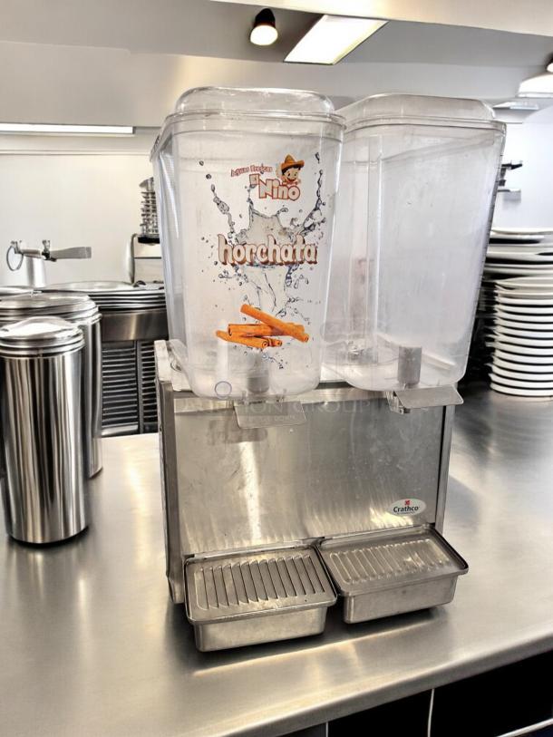 Crathco D25-3 dual bowl cold beverage dispenser in excellent condition, 115V, fully tested, with "horchata" label on the bowl.