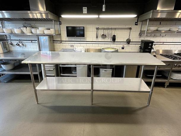 Uline Stainless Steel Worktop Table H-10348, perfect condition, fully tested. Features two-tier shelving, durable construction.