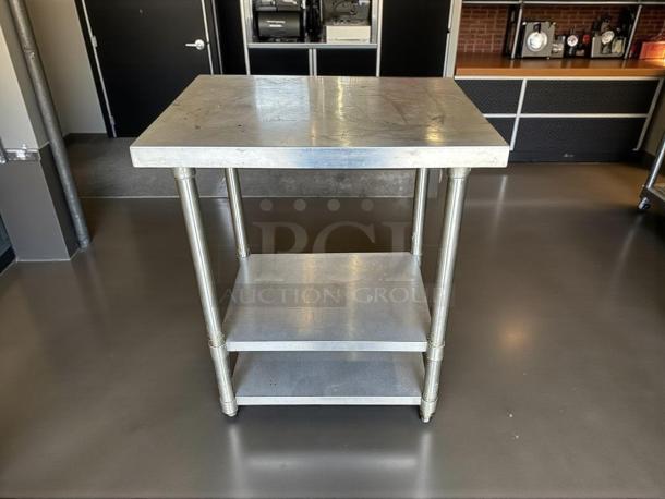 Stainless steel worktable, 30"W x 24"D x 36"H, features sturdy gauge construction, shelf, and polished finish; great condition.