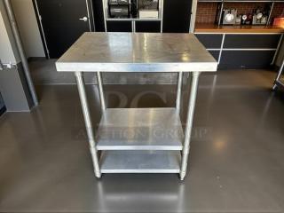 Stainless steel worktable, 30"W x 24"D x 36"H, features sturdy gauge construction, shelf, and polished finish; great condition.