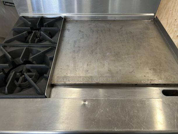 Atosa AGR-2B24GR gas range with 2 burners, 24" griddle, and oven. Stainless steel, excellent condition, fully tested.