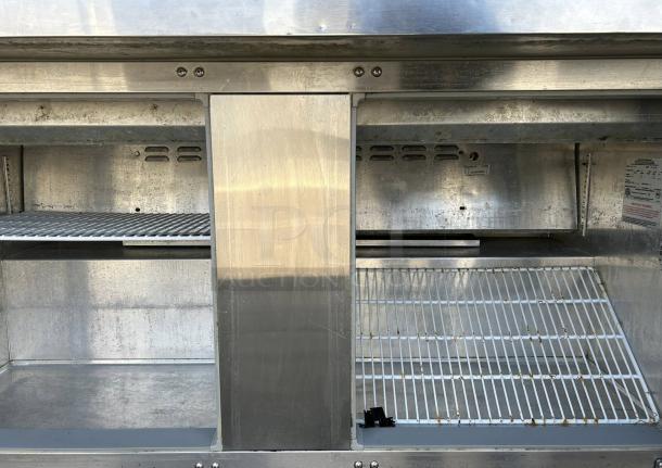 Continental SW60-24M commercial refrigerator freezer, dual lid, interior view with metal shelves, fully tested and working.