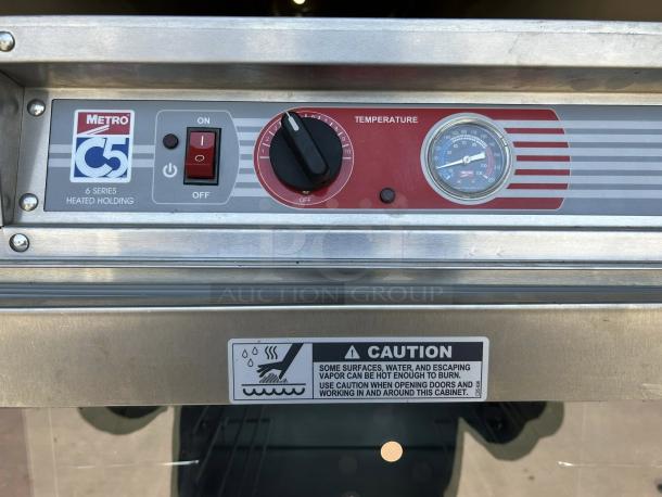 Metro C5 63L-SFC-UA heated holding cabinet control panel, showing brand logo, power switch, temperature dial, and caution label.