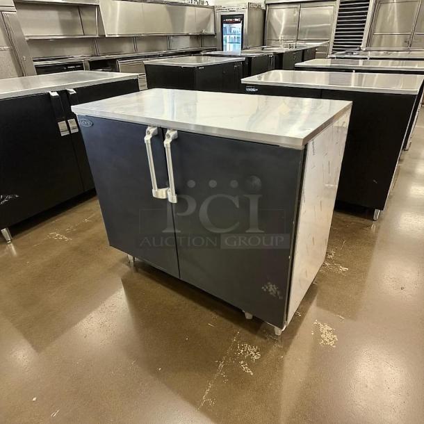 Krowne BR48 48" dry back bar cabinet with 2 solid black doors; in amazing condition; tested and working.