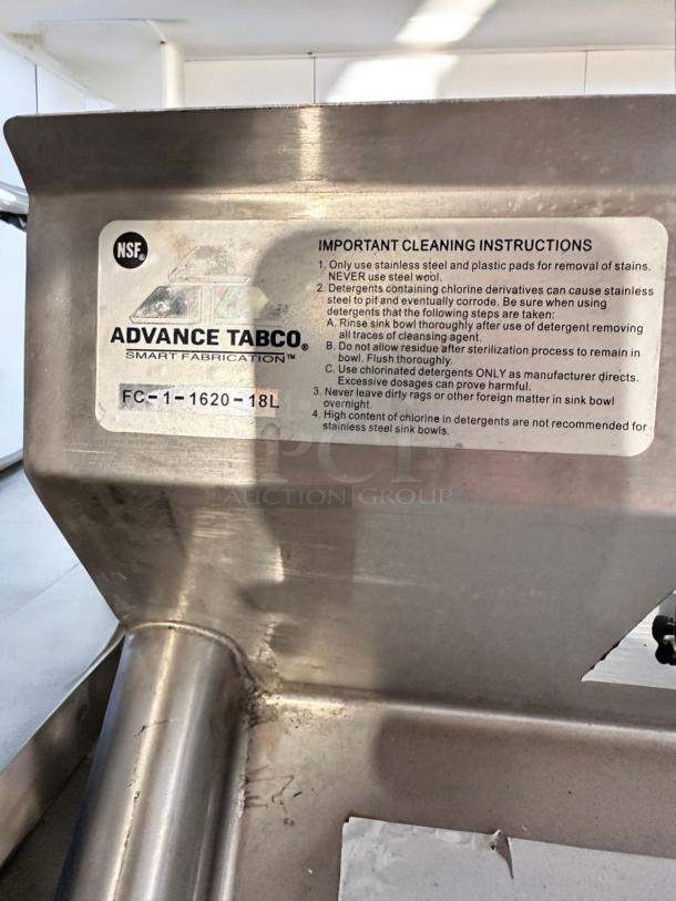 Brand new Advance Tabco FC-1-1620-18L stainless steel sink with NSF certification and left drainboard, cleaning instructions visible.