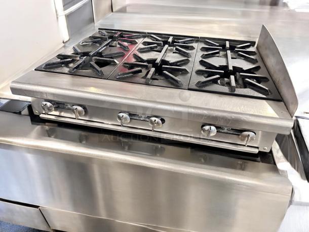 Imperial 6-burner gas range, stainless steel, excellent condition, fully tested. Durable controls, ideal for heavy-duty use.
