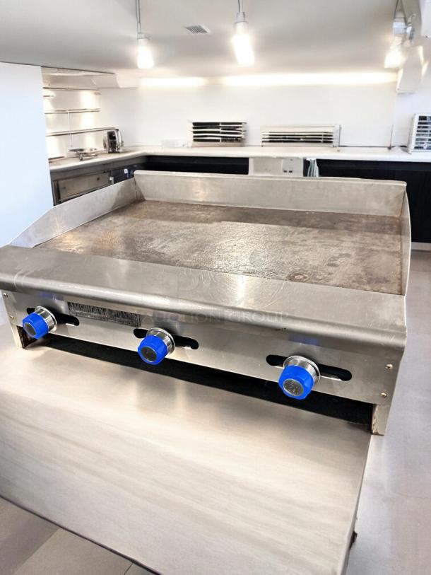 American Range ARMG-36 gas griddle, 36", manual controls, excellent condition, fully tested, blue knobs, stainless steel finish.