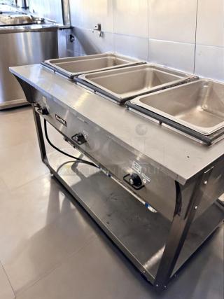 ServeWell SRP12 4-Pan Steam Table in pristine condition, 120V, fully tested, stainless steel, and ready for use.