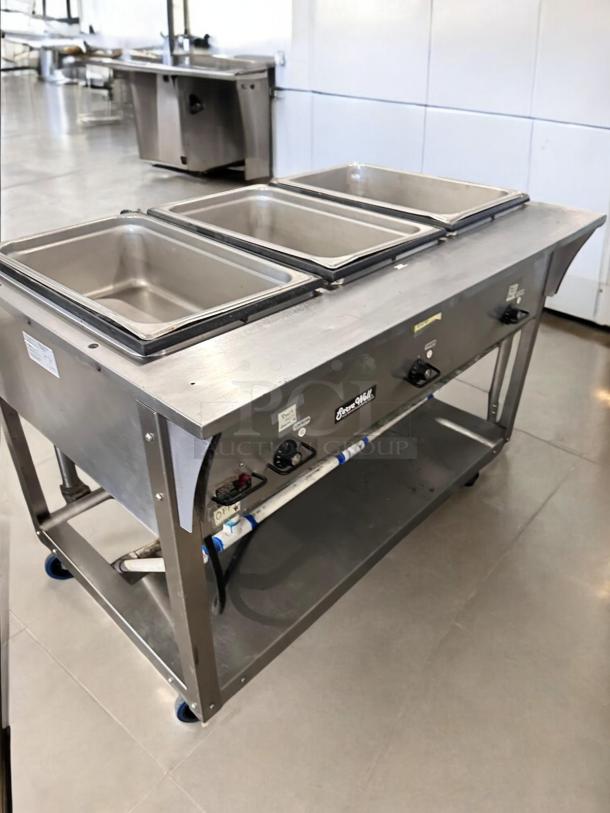 ServeWell SRP12 4-pan steam table in pristine condition, 120V, stainless steel, fully tested, clearly labeled controls visible.
