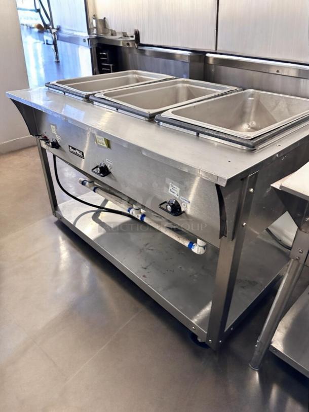 Pristine ServeWell SRP12, 4-pan steam table, 120V, fully tested. Stainless steel, labels, controls visible, great condition.