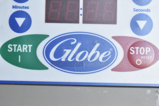 Close-up of control panel on Globe SP30 commercial dough mixer, showing start, stop buttons, and digital display.