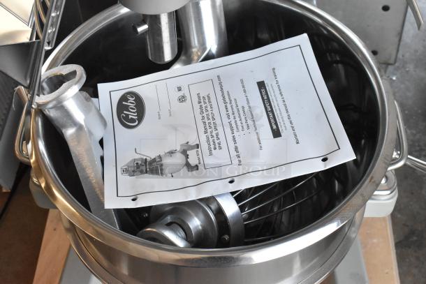 Brand new Globe SP30 30-quart planetary dough mixer with bowl, guard, hook, whisk, paddle, and manual visible.