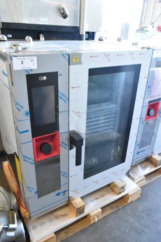 Brand new Bakers Pride AETG101R stainless steel combi convection oven, natural gas, with protective film, on pallet.