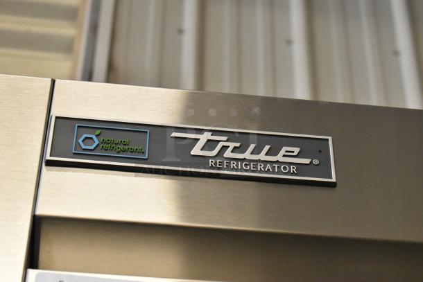 True T-35-HC stainless steel cooler with "Natural Refrigerant" label, new condition. 2-door, 115V, poly-coated racks.