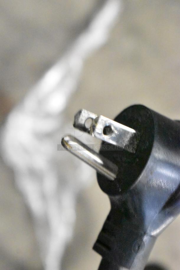 Close-up of a black power plug and prongs for the 2017 True T-19F commercial reach-in freezer, 115V, 1 phase.
