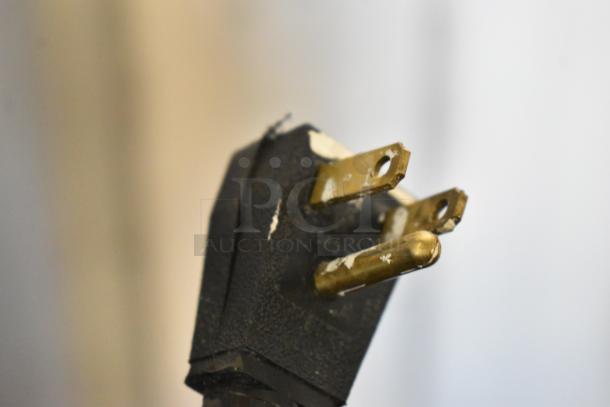 Close-up of the power plug for the 2017 True T-19F stainless steel commercial freezer, showing wear. 115 volts, 1 phase.