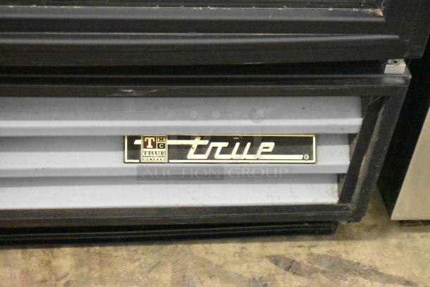 True GDM-12 single door reach-in cooler, metal frame, poly-coated racks, 115 volts, featuring brand nameplate.