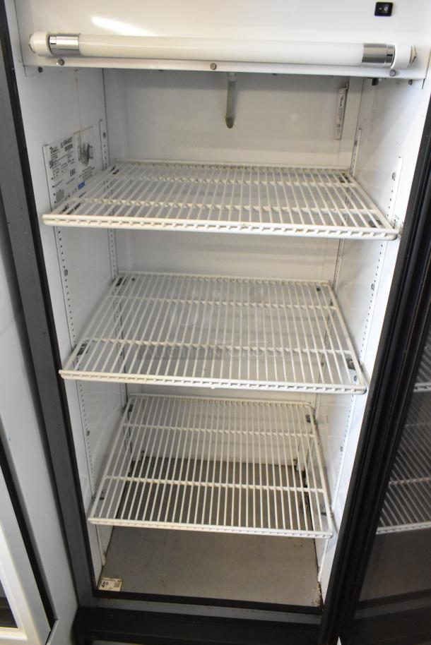 True GDM-12 metal commercial cooler with single door, poly-coated racks. 115V, 1 phase. Clean interior, minor wear.